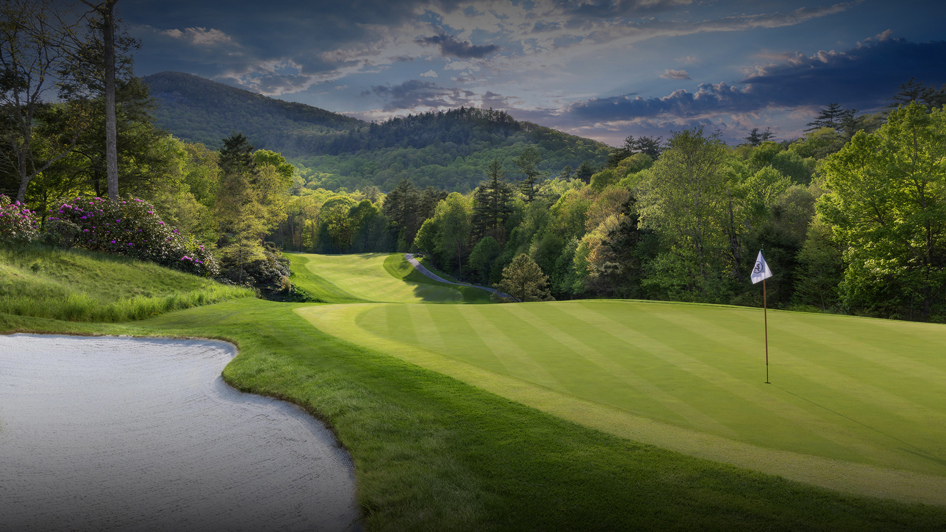 a golf course with a river running through it