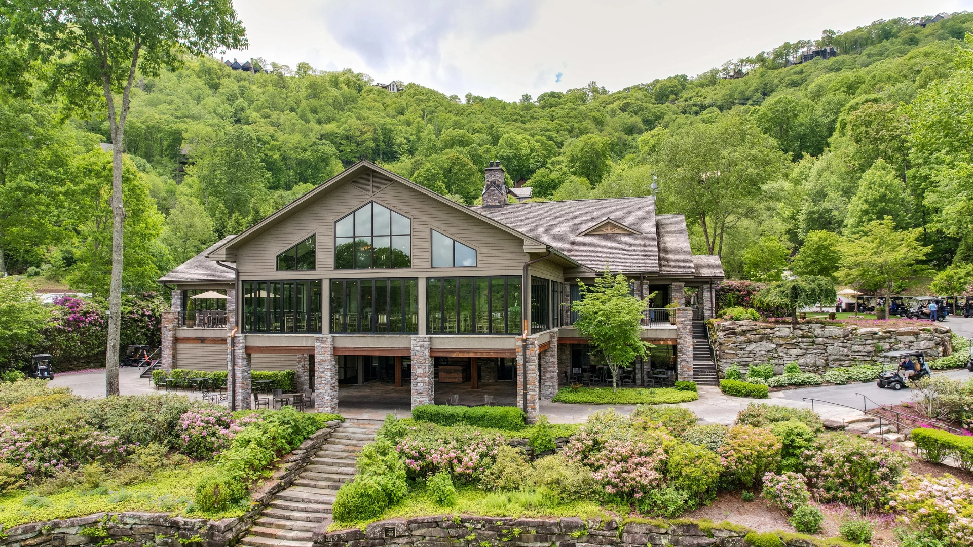 a large house with a large stone wall and a stone walkway