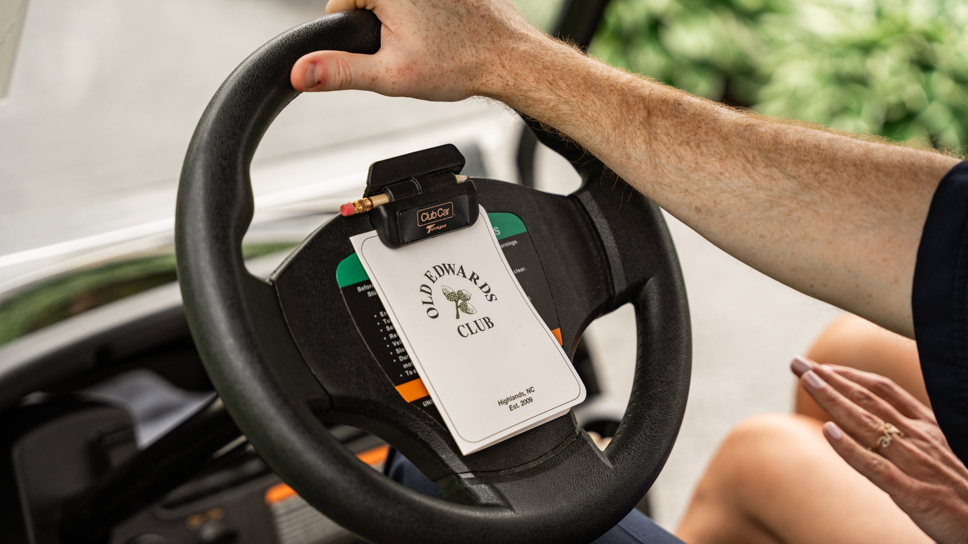 a person holding a steering wheel