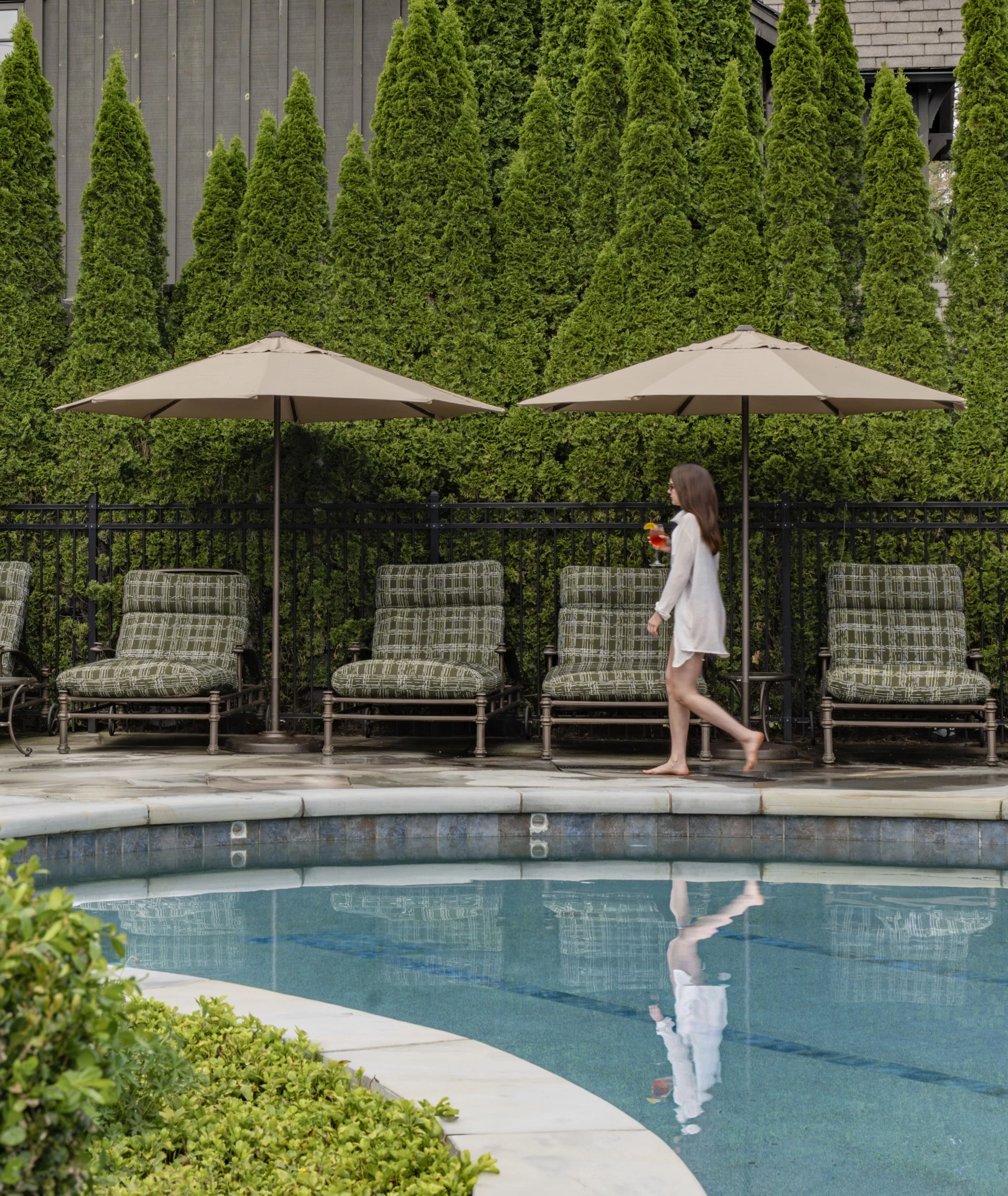 a woman walking by a pool