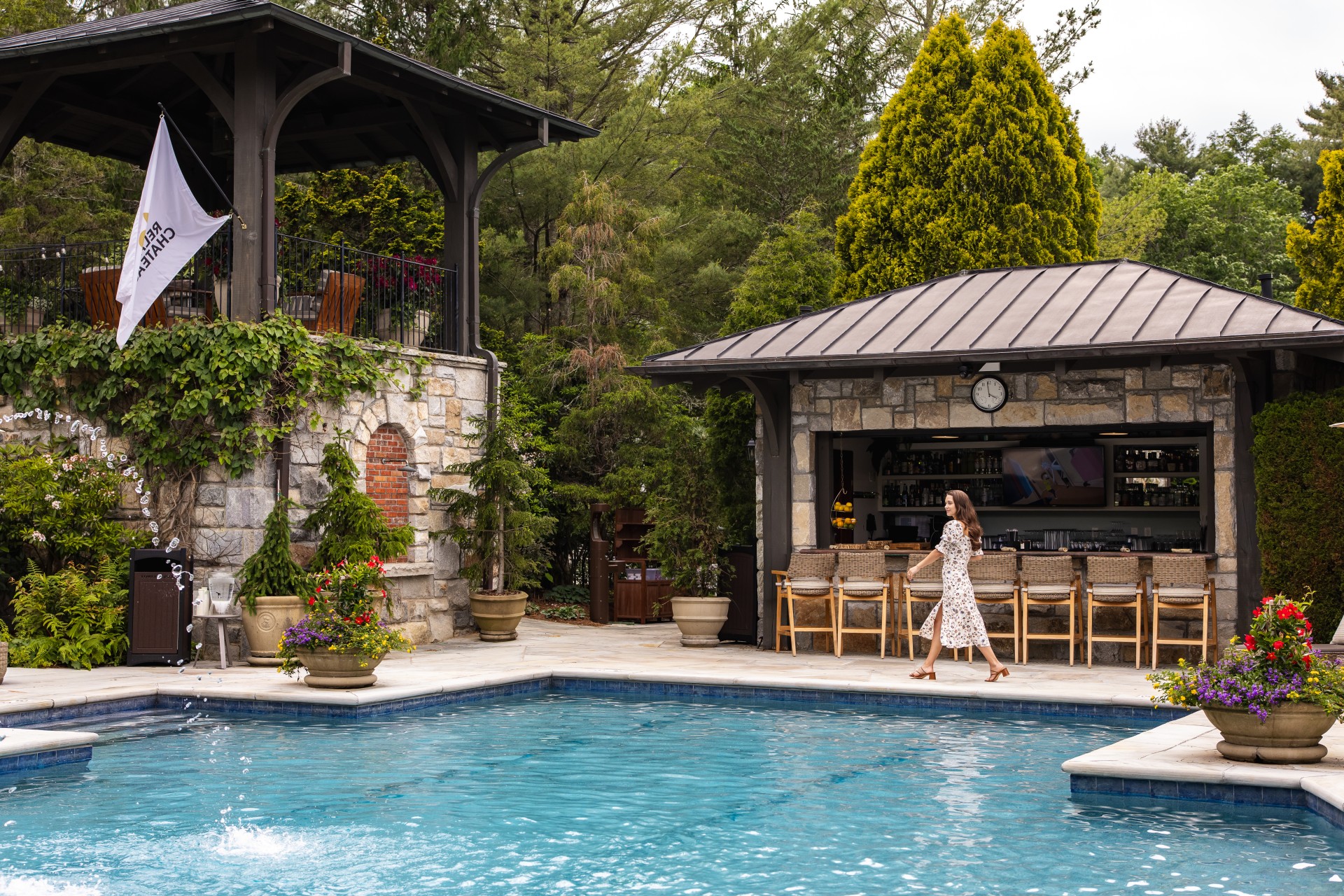 a woman walking by a pool