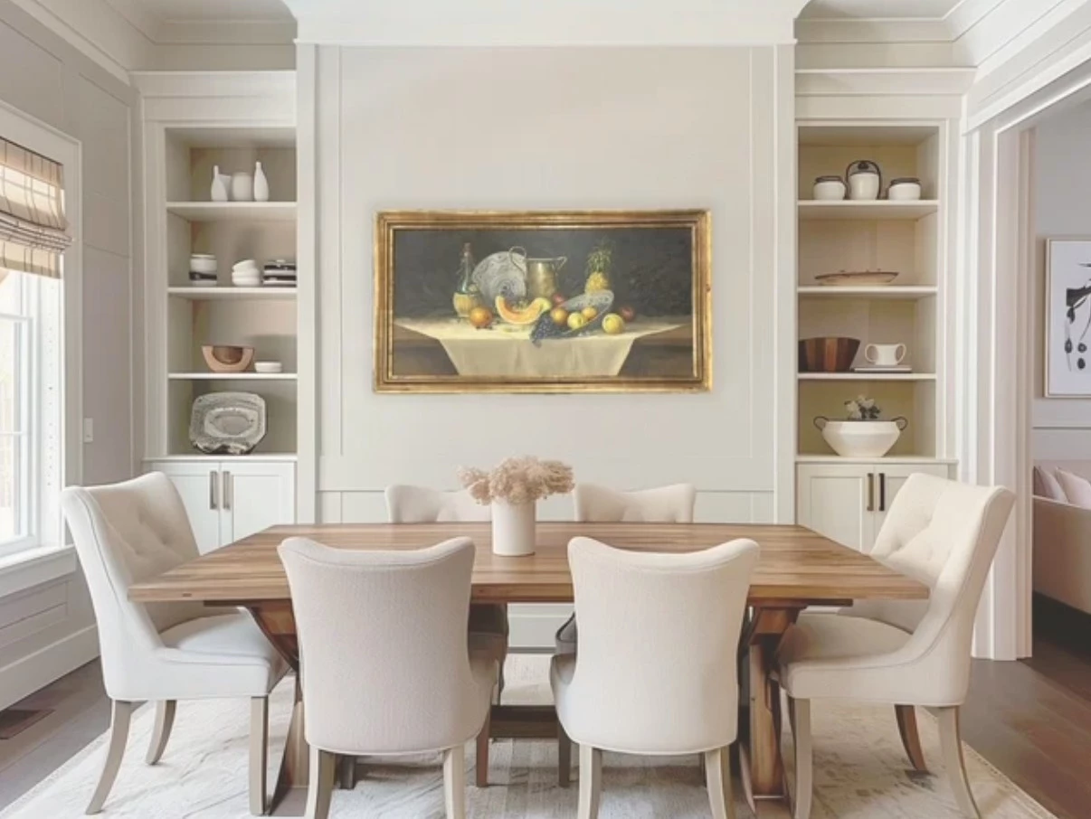 a dining table with chairs and a painting on the wall