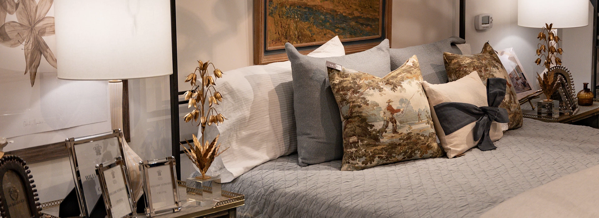 a couch with pillows and a gold plant on the side