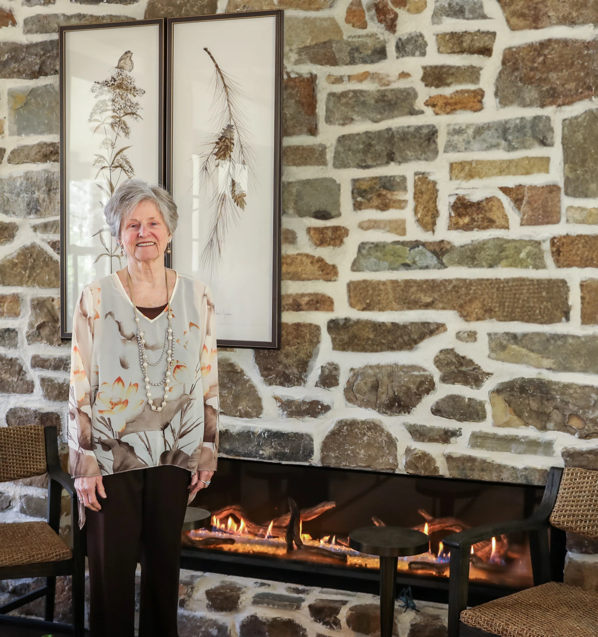 a woman standing in front of a fireplace