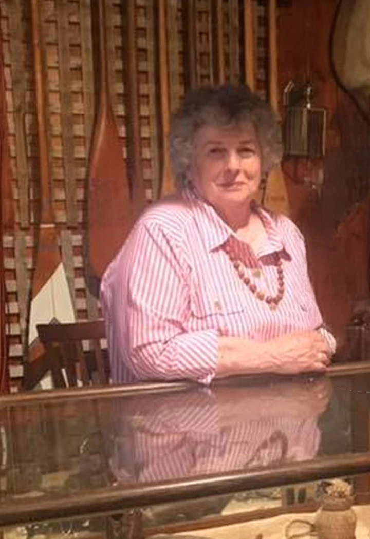 a woman leaning against a counter
