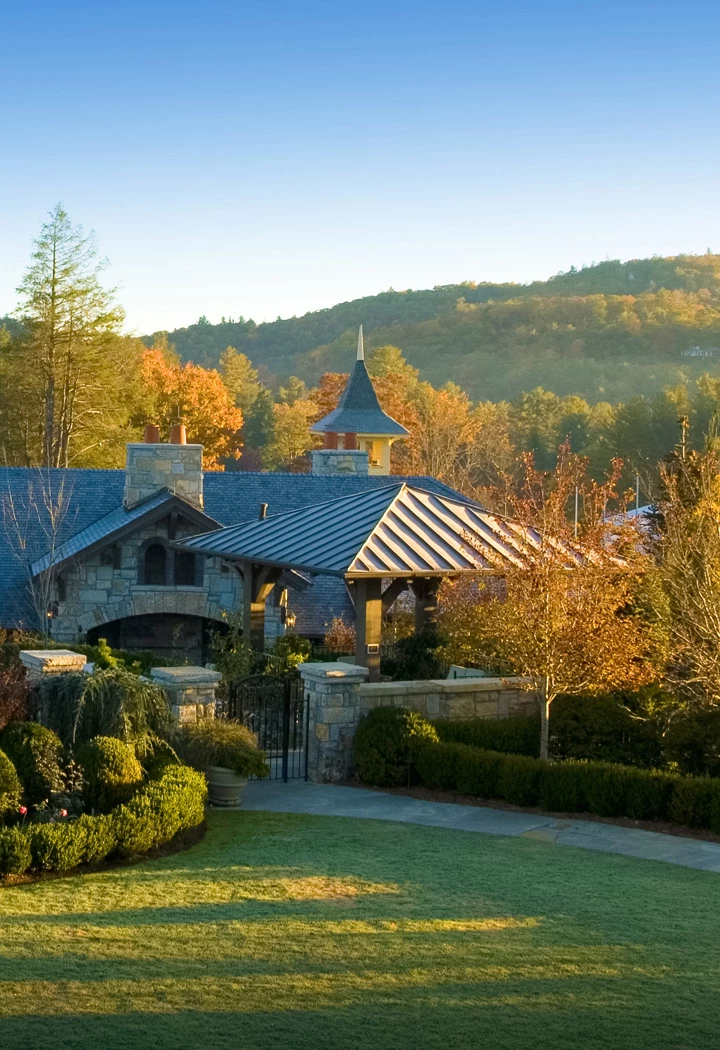 a house with a gate and trees