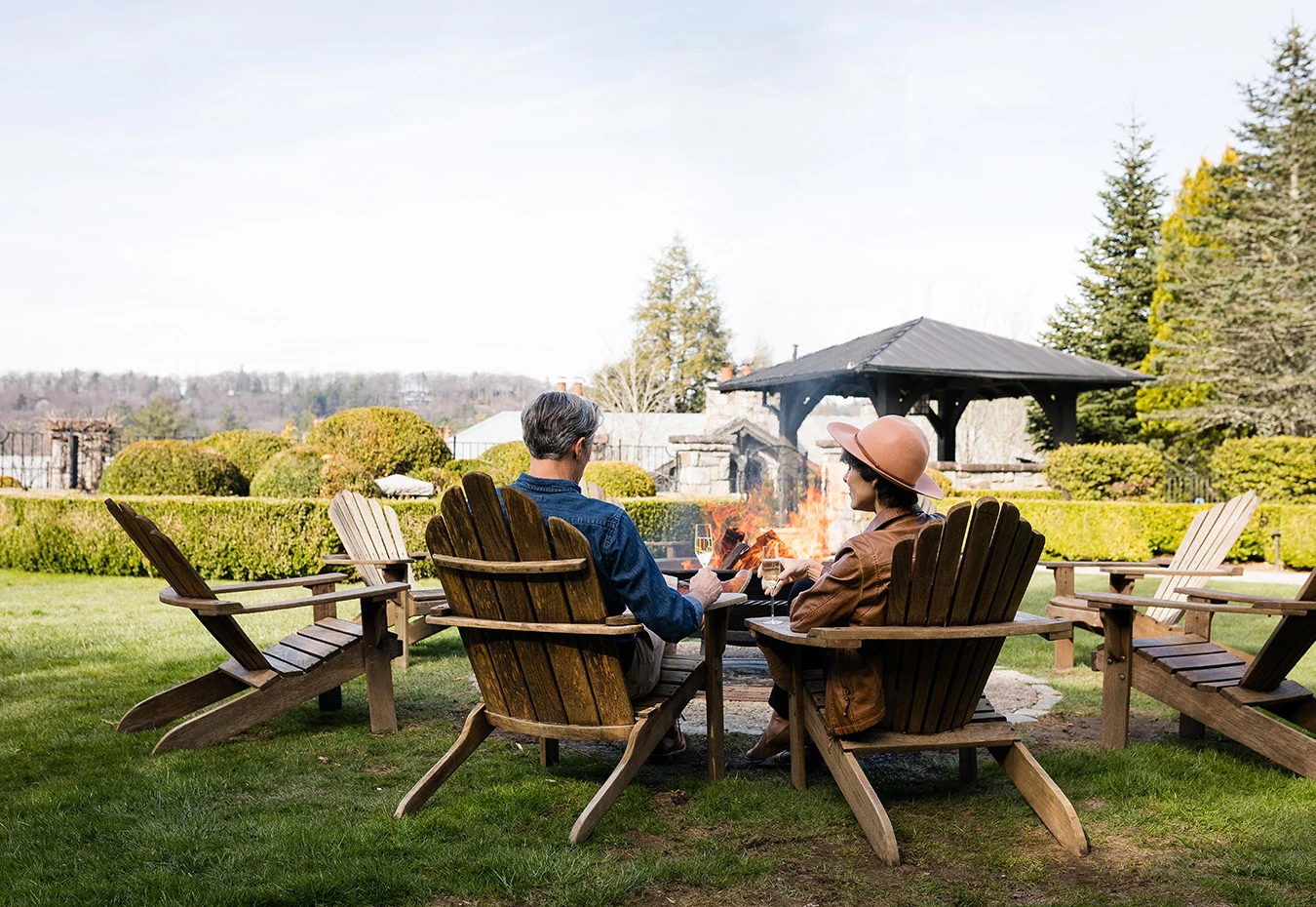 a couple sitting at a table with fire