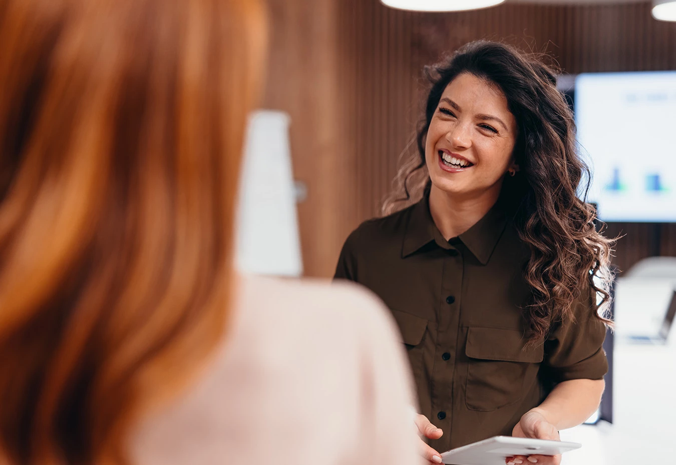 a woman smiling at another woman