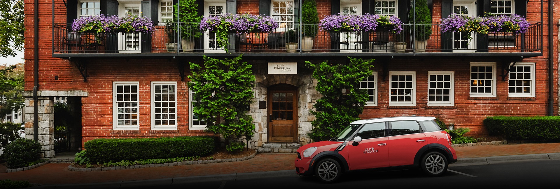 a red car parked in front of a building