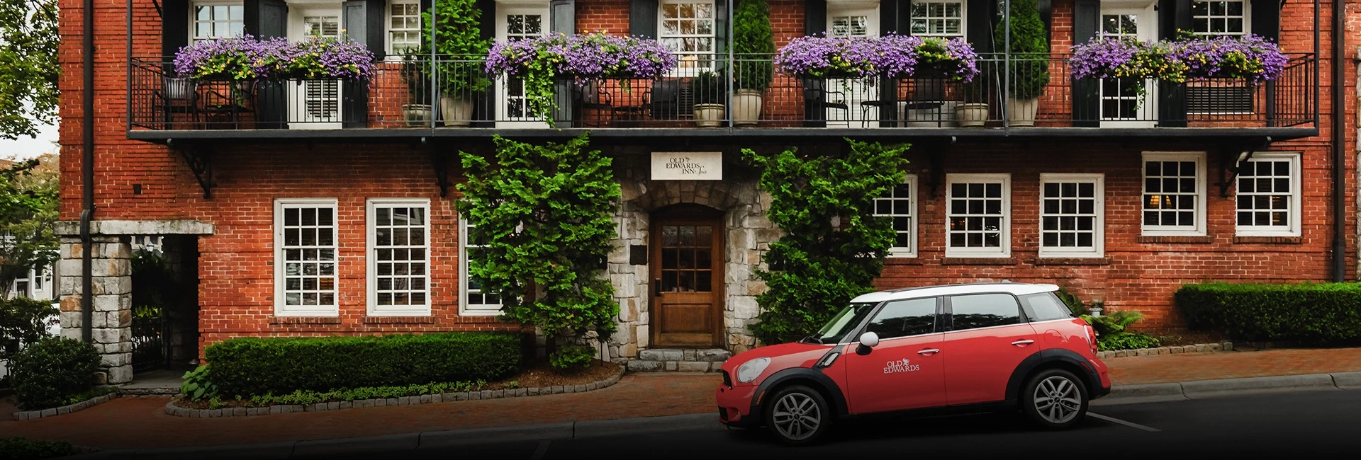 a red car parked in front of a building