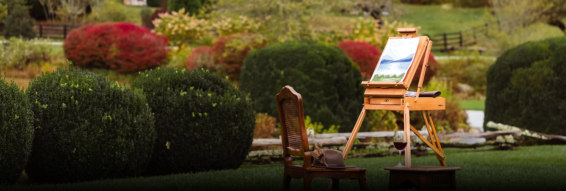 a chair and a painting easel in a yard