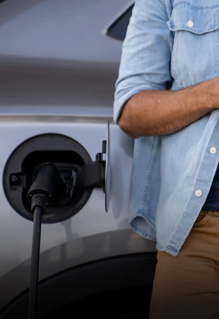 a man standing next to a car