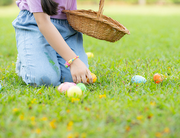 a child picking up an egg
