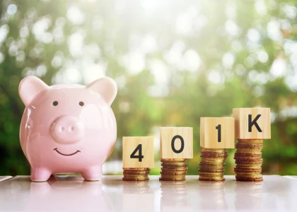 a piggy bank with wooden blocks and stacks of coins