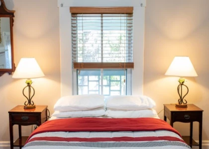 a bed with a red and white striped bedding