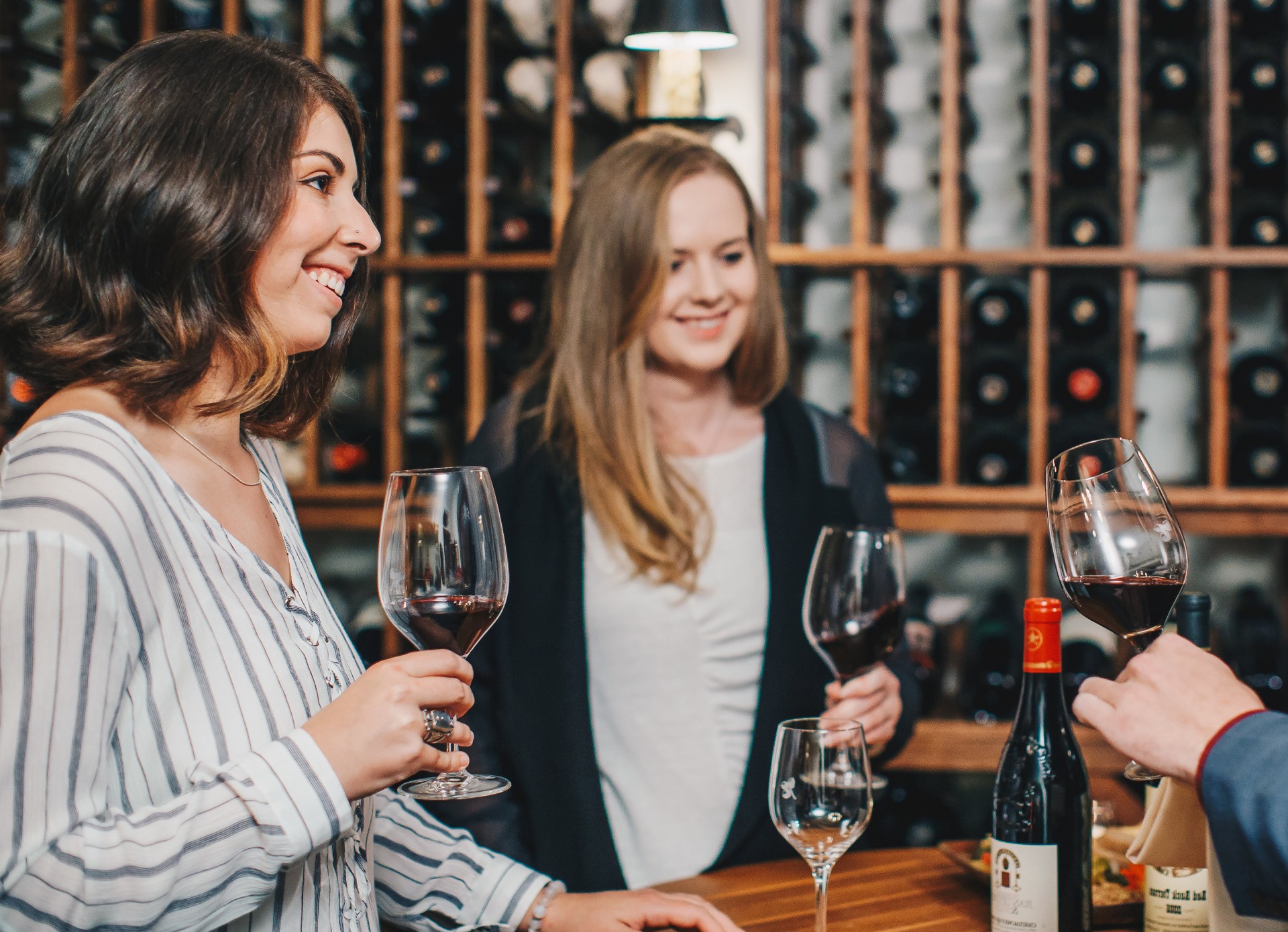 a group of women holding wine glasses