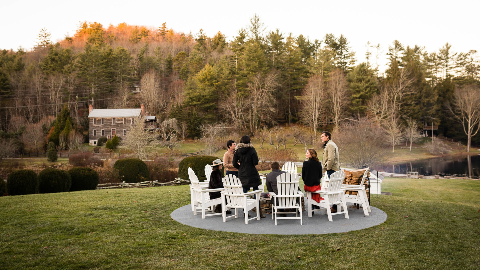 a group of people sitting around a fire pit