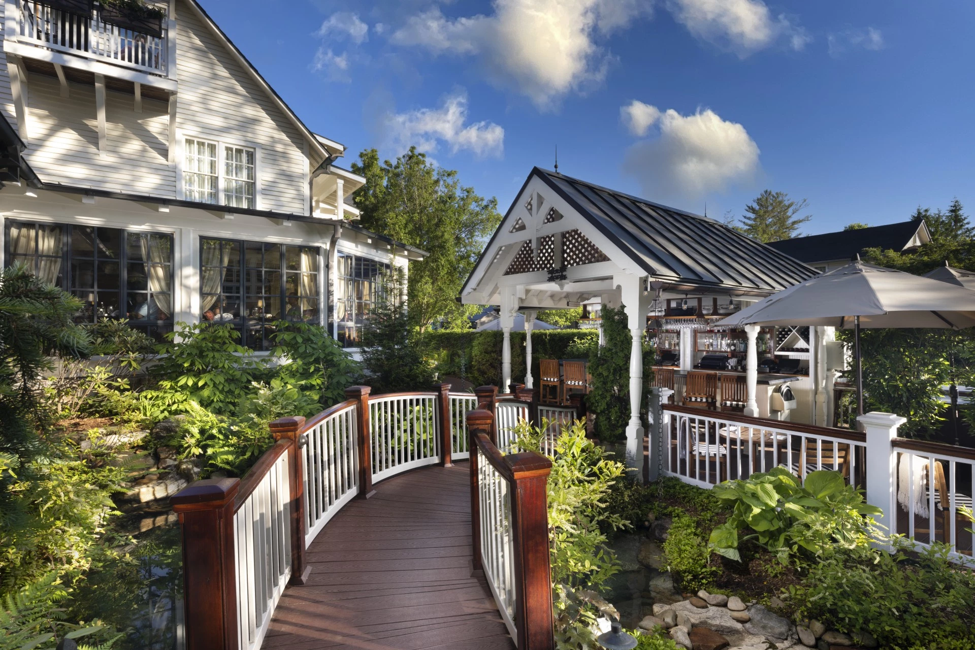 a bridge over a river with trees and plants