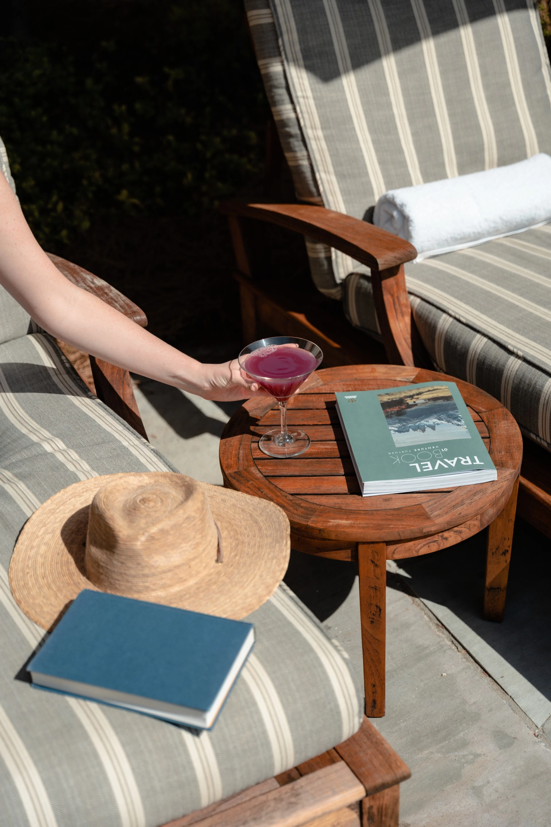 a hand holding a drink on a table
