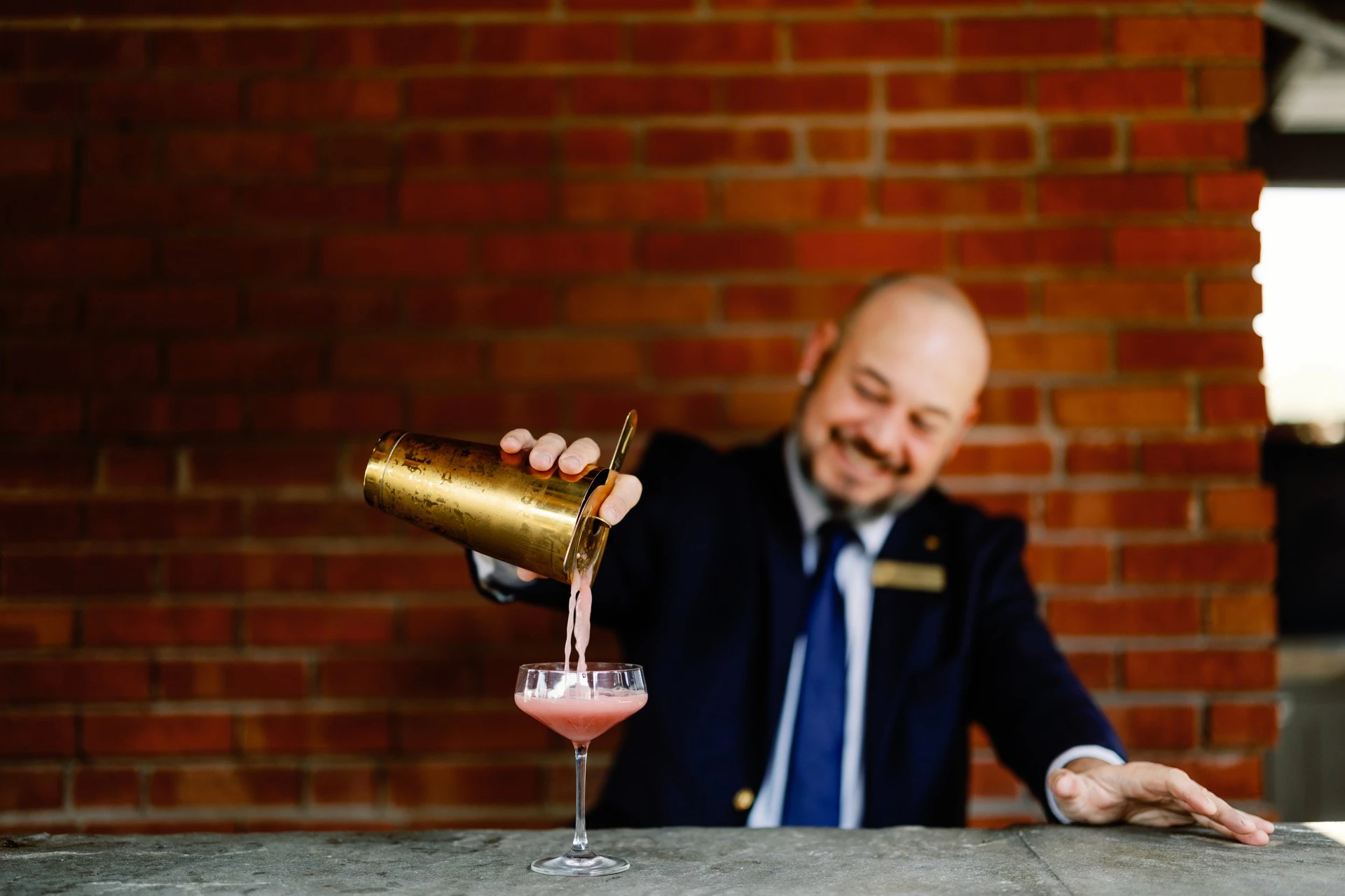 a man pouring a drink into a glass