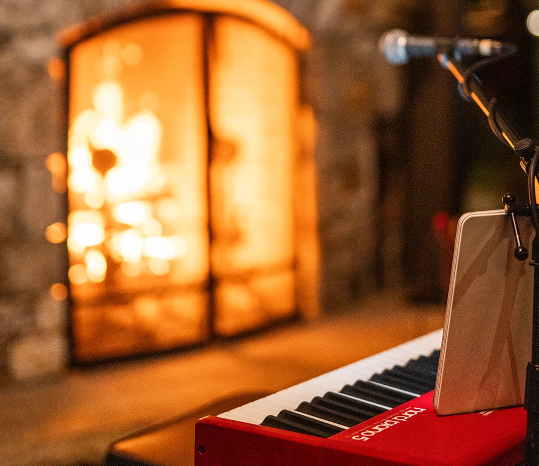 a piano with a microphone in front of a fire