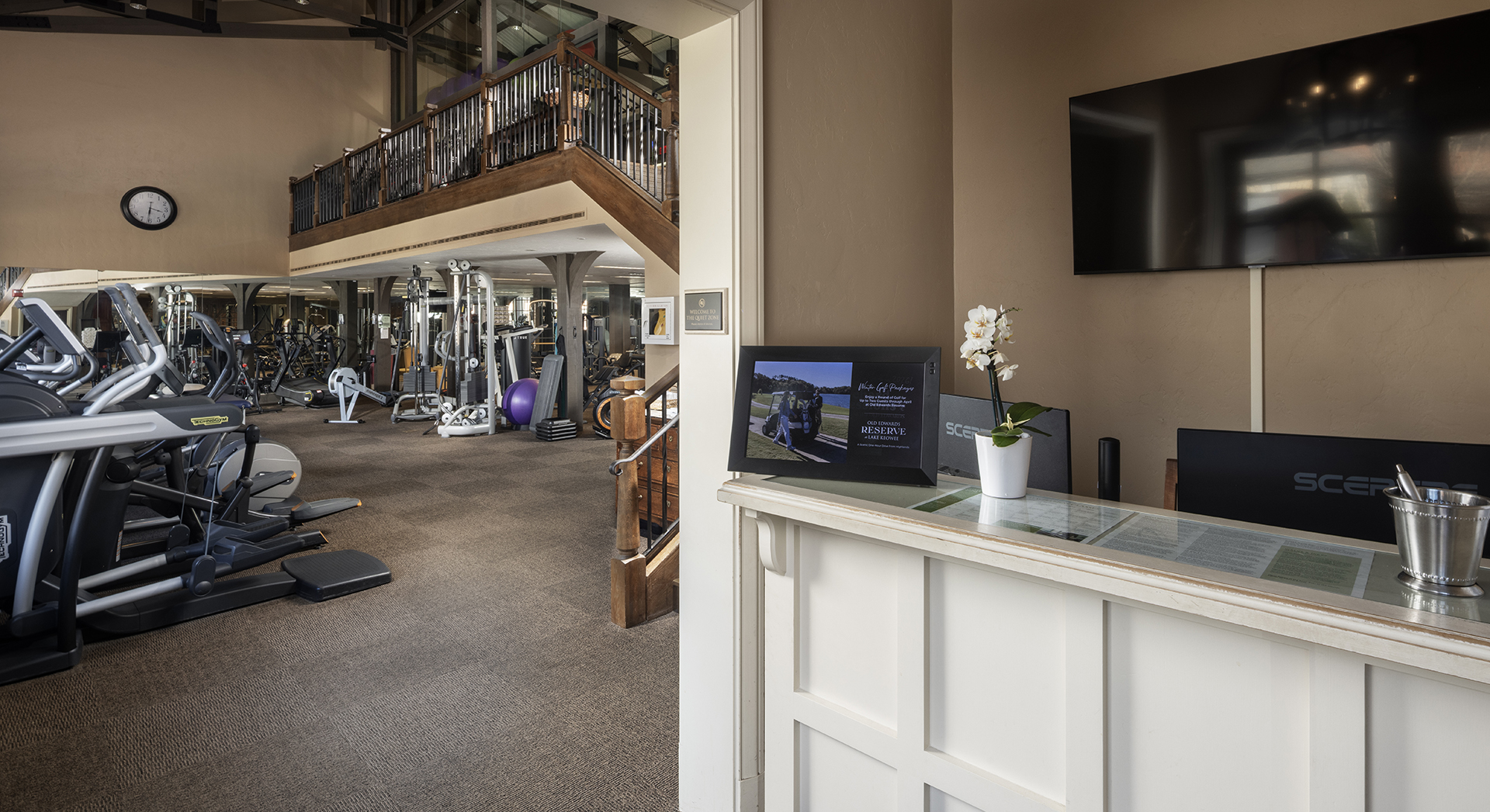 a gym with a television and exercise equipment