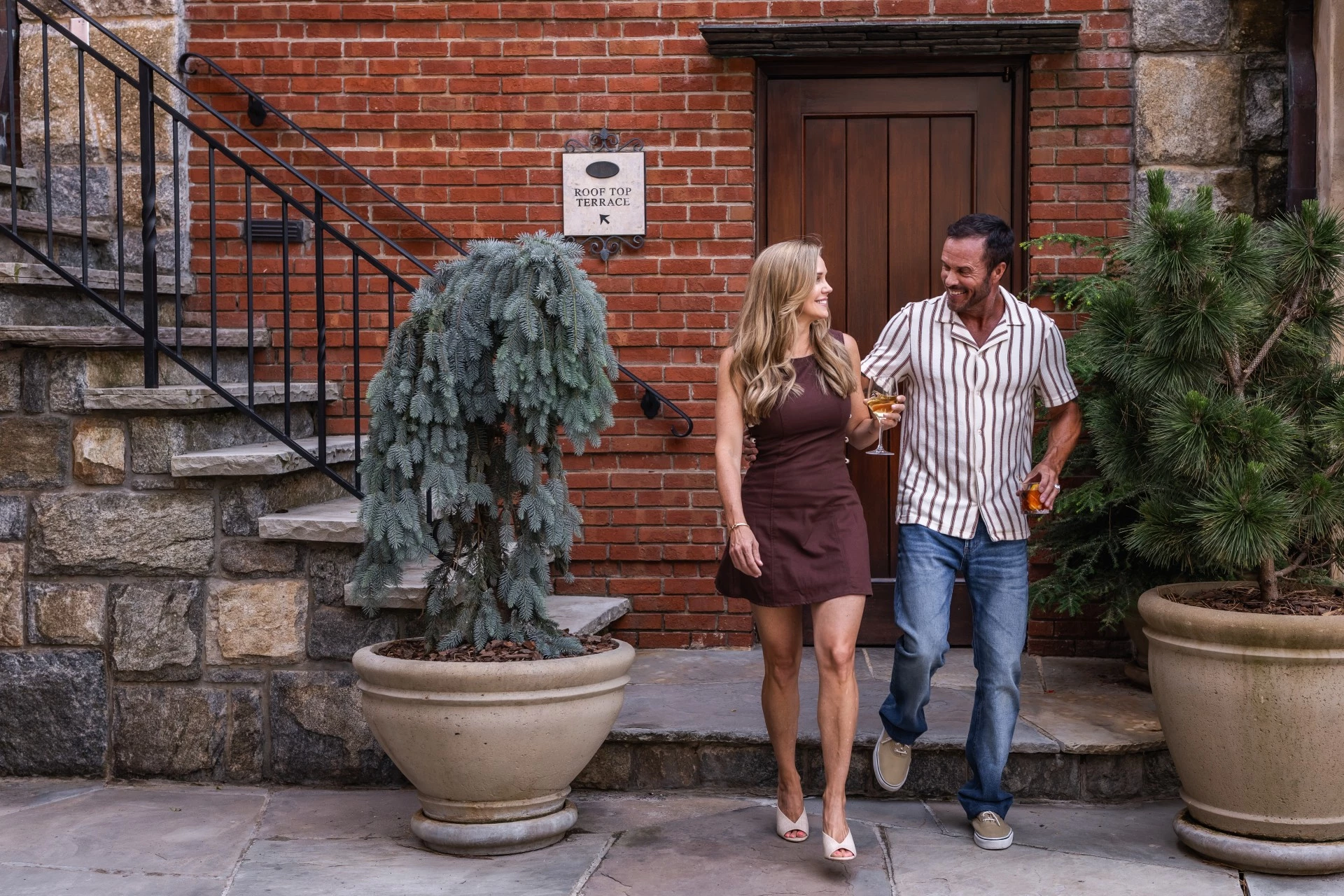 a man and woman walking down the steps