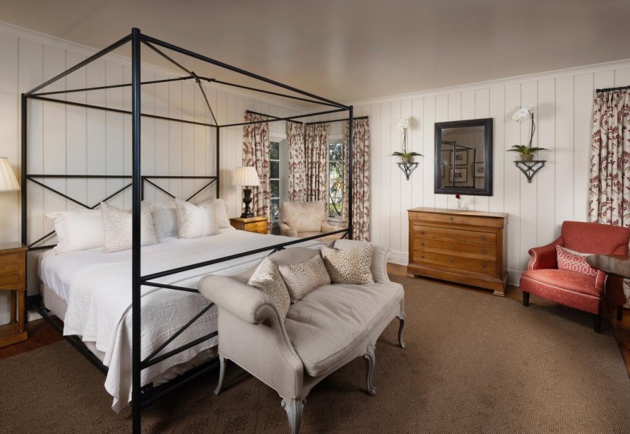 a bedroom with a bed and a couch