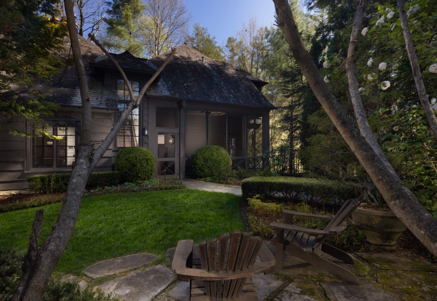 a house with a lawn and chairs