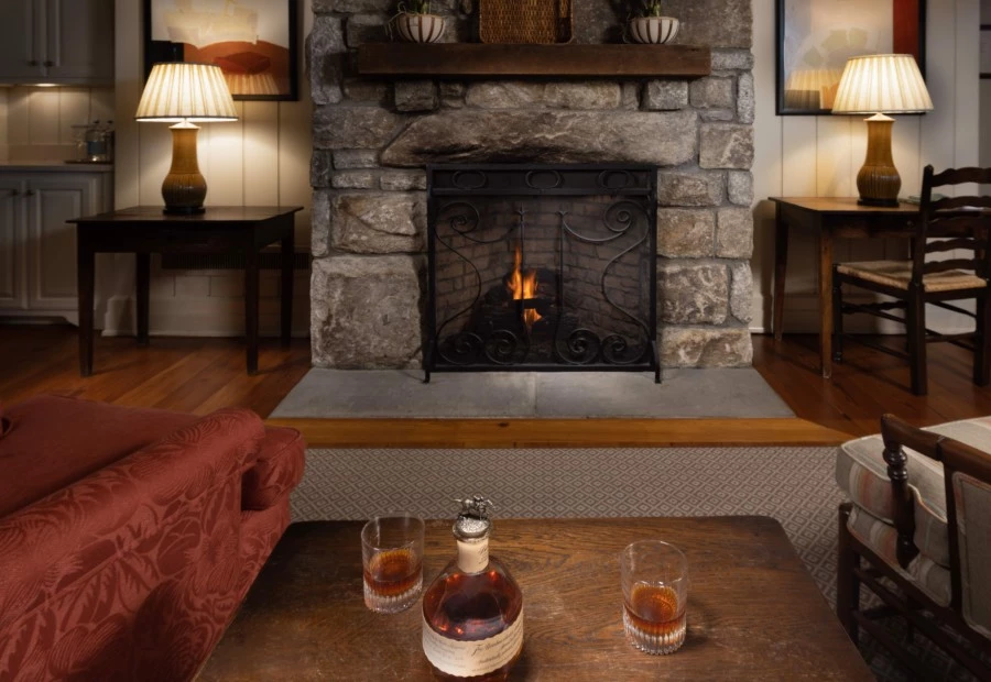 a table with glasses and a bottle of alcohol on it