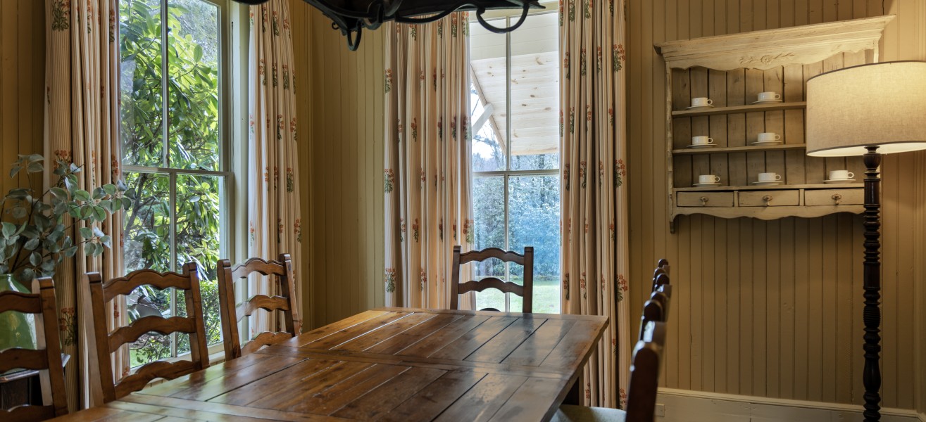 a dining table with chairs and a chandelier