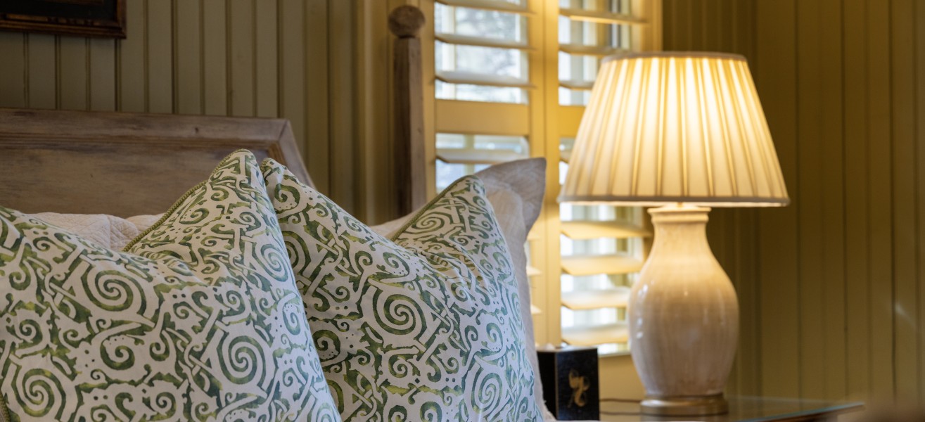 a bed with pillows and a lamp