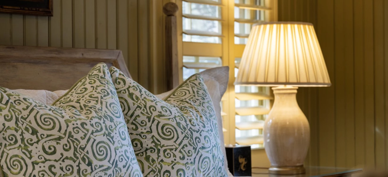 a bed with pillows and a lamp