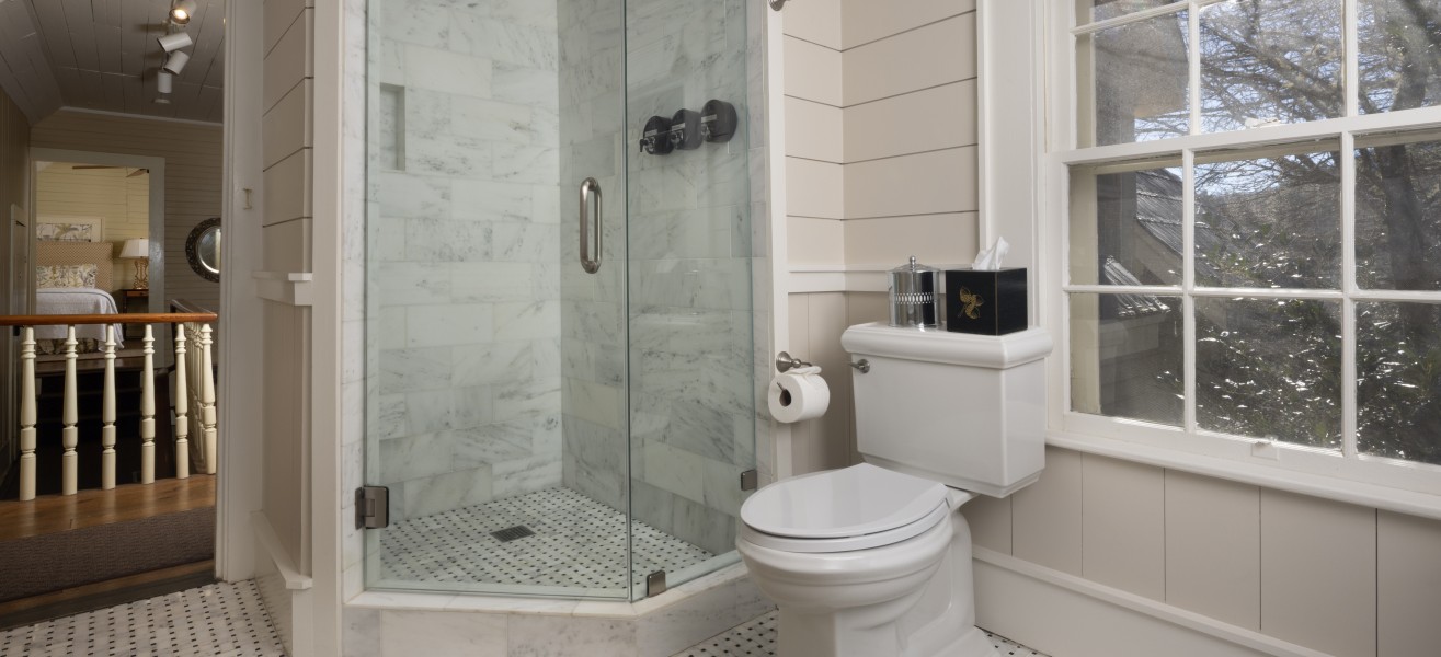 a bathroom with a glass shower and a toilet