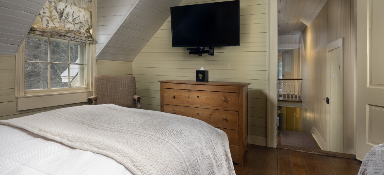 a bedroom with a tv on the wall