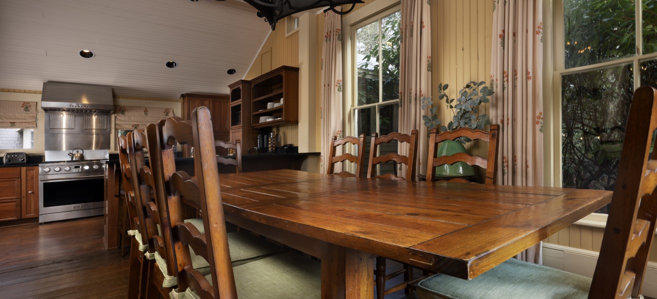 a dining table with chairs and a chandelier