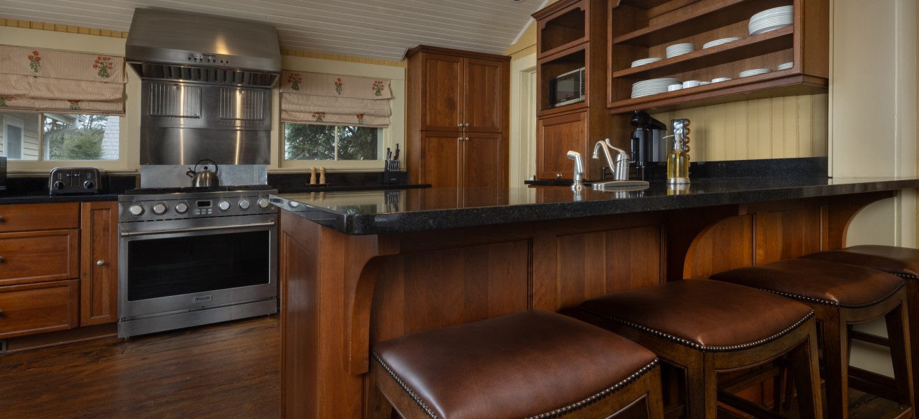 a kitchen with a bar and stools