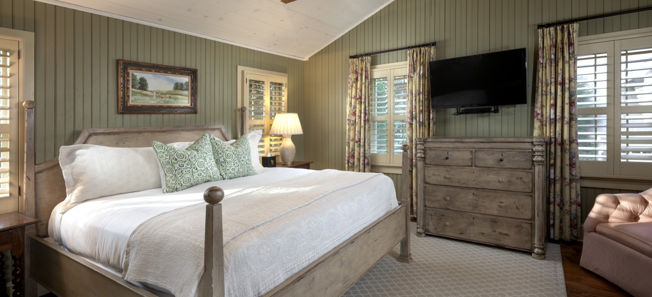 a bedroom with a bed and a television