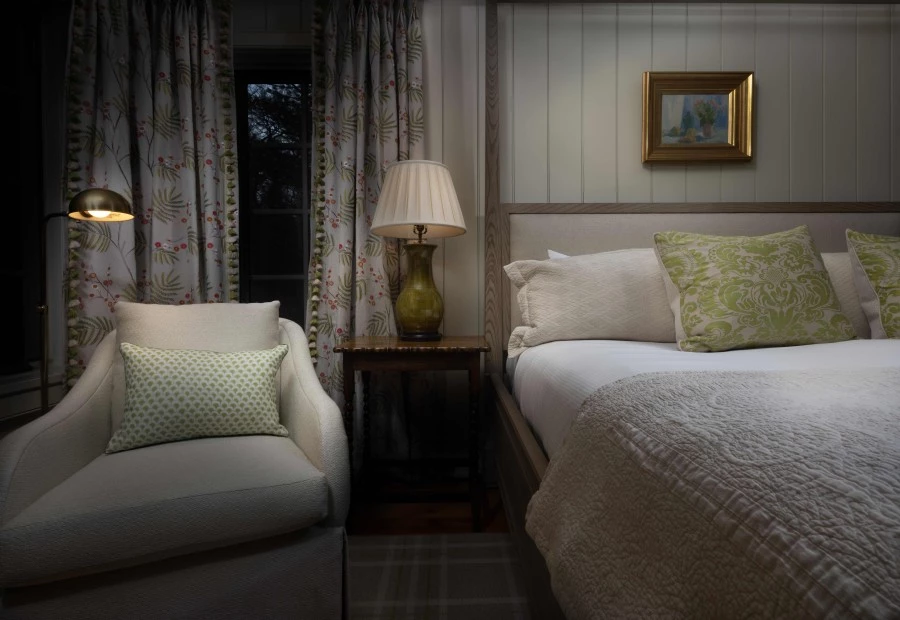 a bedroom with a bed and a lamp