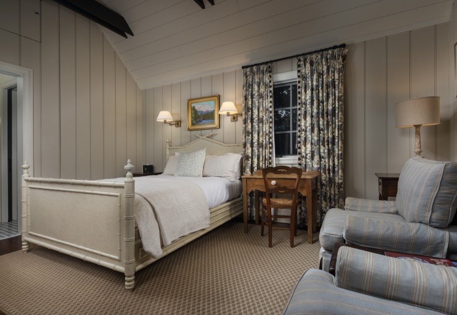 a bedroom with a bed and a chair