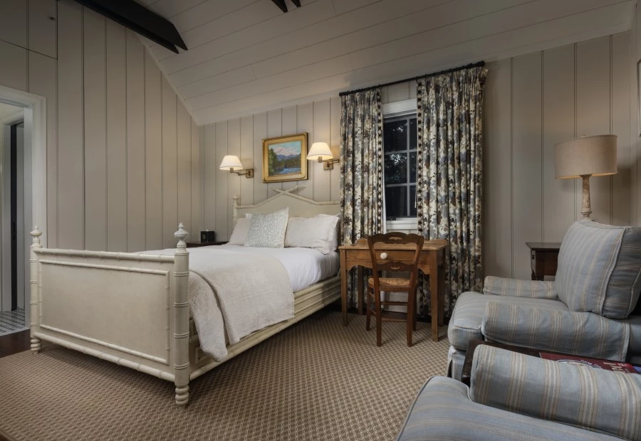 a bedroom with a bed and a chair