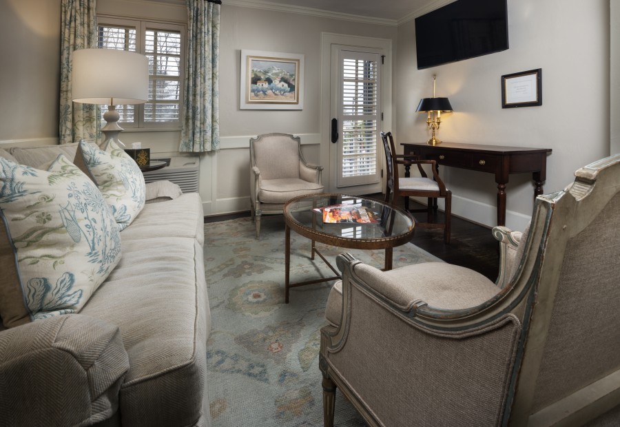 a living room with a couch and chairs