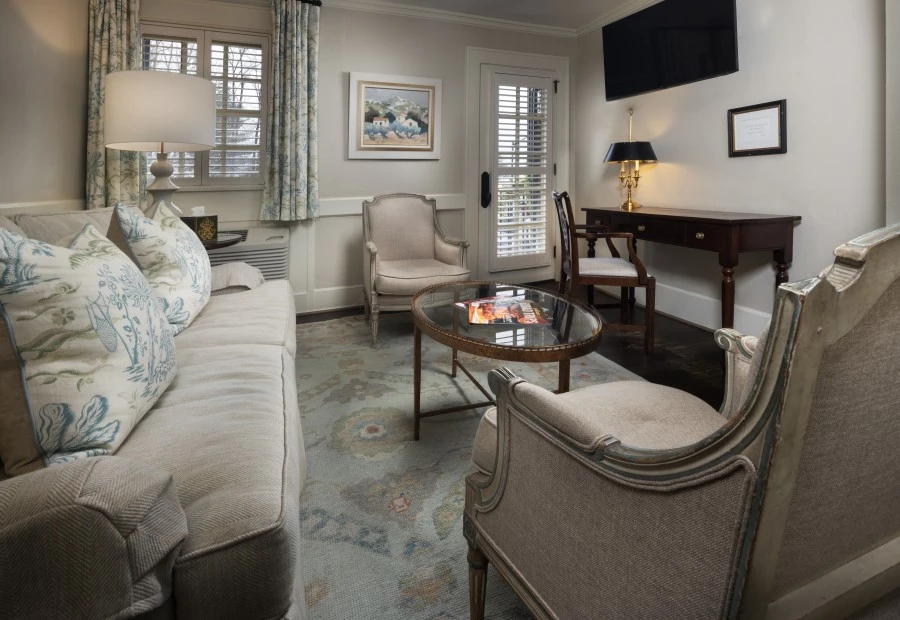 a living room with a couch and chairs