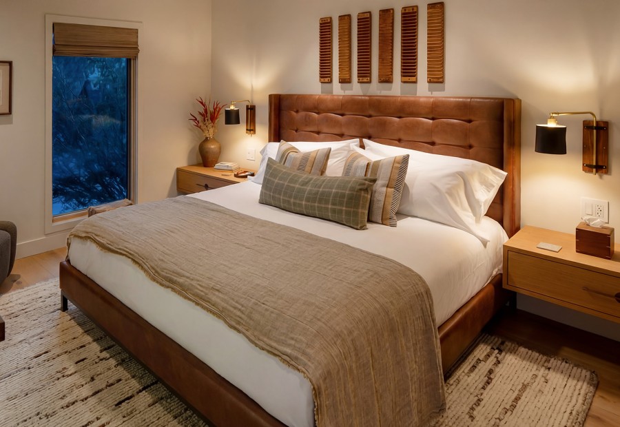 a bed with pillows and a lamp