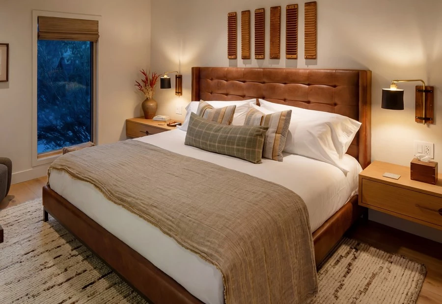 a bed with pillows and a lamp
