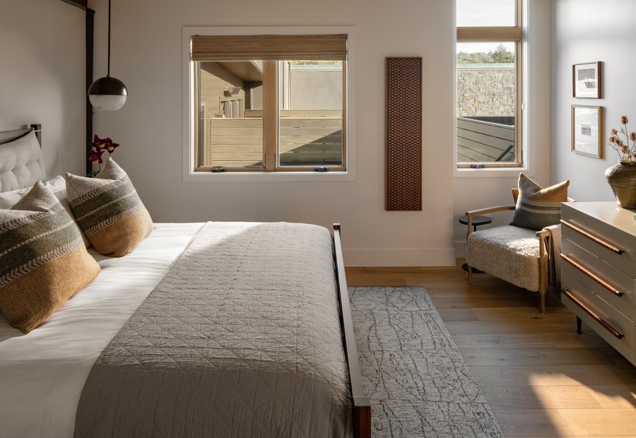 a bedroom with a bed and a chair