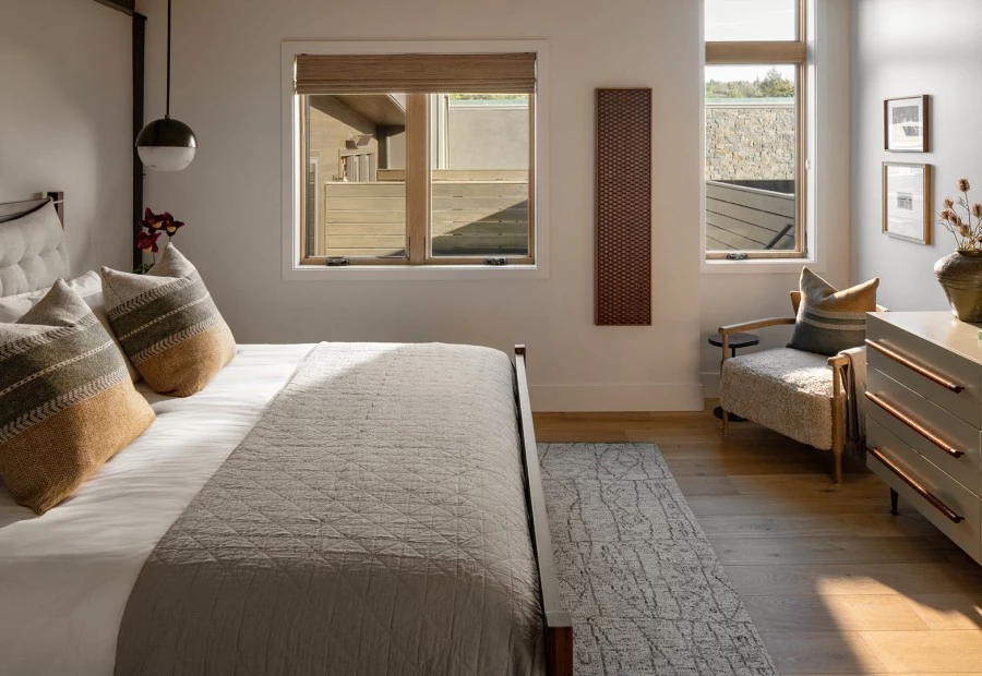 a bedroom with a bed and a chair