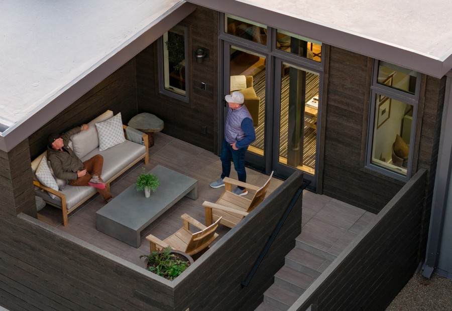 a couple of men sitting on a patio