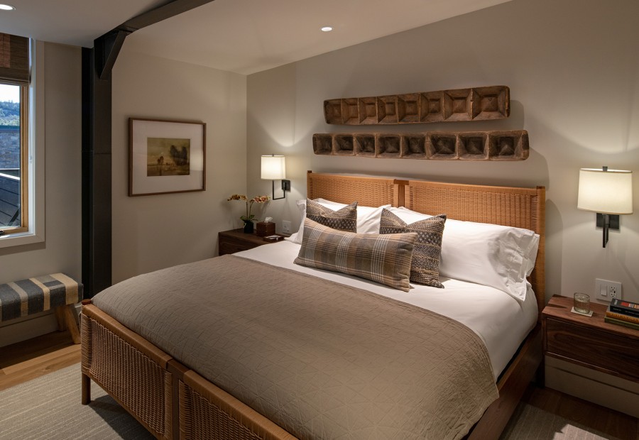 a bed with pillows and a lamp