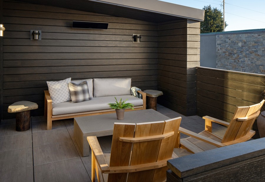 a patio with a couch and chairs